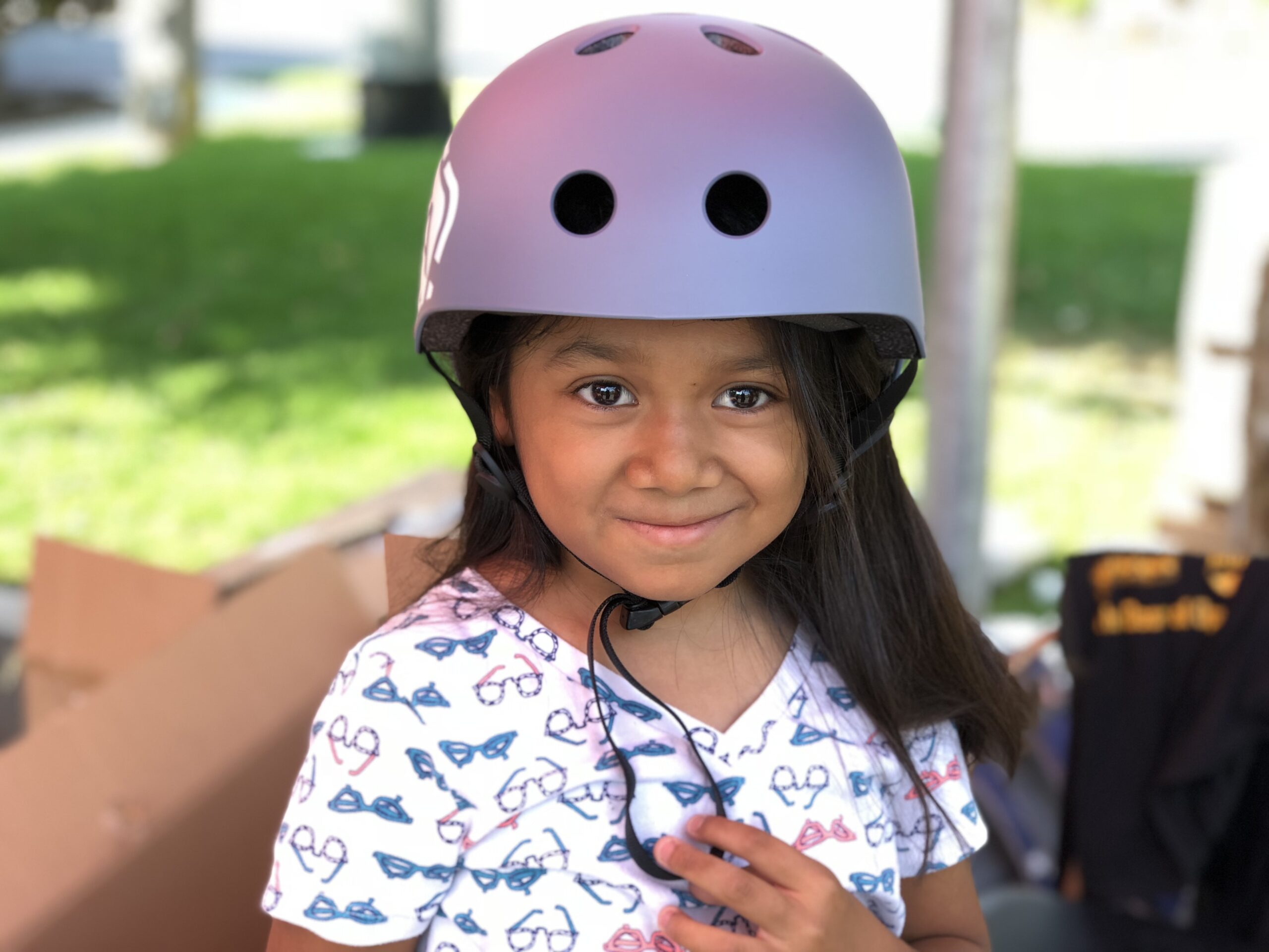 little girl in a purple helmet